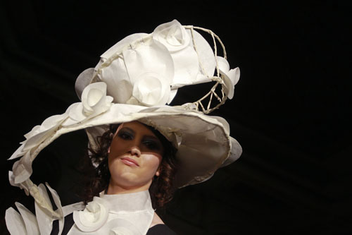 A student presents a creation made of recyclable materials during a fashion show in Bucharest March 1, 2010.