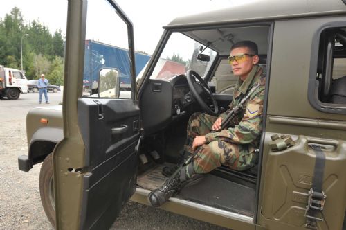 A soldier watches the cars at a tolling station in Concepcion, Chile, March, 2, 2010. Thousands of soldiers have been deployed in Concepcion as the lack of power, drinking water and food caused panic among residents in Concepcion, triggering looting in supermarkets and food stores.[Song Weiwei/Xinhua] 