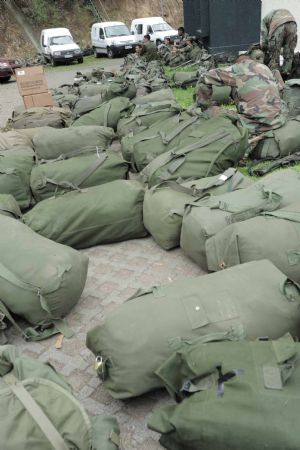 Soldiers rest at a tolling station in Concepcion, Chile, March, 2, 2010. Thousands of soldiers have been deployed in Concepcion as the lack of power, drinking water and food caused panic among residents in Concepcion, triggering looting in supermarkets and food stores. [Jorge Villegas/Xinhua] 