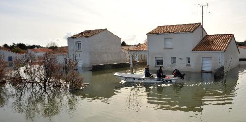 Rescue workers search for the missing in a flooded residential neighborhood in La-Faute-sur-Mer, western France, March 2, 2010 after a major storm named Xynthia hit western Europe, killing at least 62. [Xinhua] 