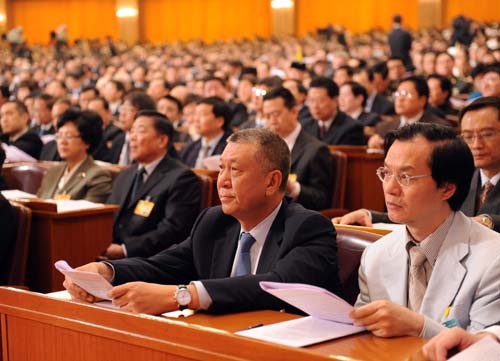 Edmund Ho Hau Wah (2nd R, front), a member of the 11th National Committee of the Chinese People's Political Consultative Conference (CPPCC), attend the opening meeting of the Third Session of the 11th CPPCC National Committee at the Great Hall of the People in Beijing, capital of China, March 3, 2010.
