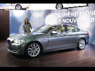 The new BMW 5 is displayed at the exhibition stand of Audi during the 80th Geneva Motor Show at the Palexpo in Geneva March 2, 2010. [Sina.com.cn]