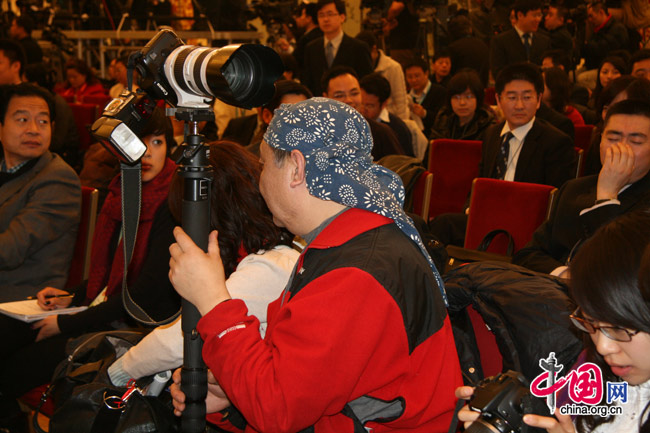 A photographer at a press conference of the 3rd session of the 11th National People's Congress (NPC) in the Great Hall of the People in Beijing, March 4, 2010. [Li Shen/China.org.cn]