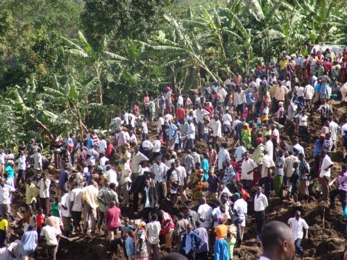 Rescuers search for survivors and victims of the landslide at Nametsi village in Bududa District, about 370 kilometers east of the Ugandan capital Kampala, on March 3, 2010. Soldiers and villagers in eastern Uganda hacked at mounds of thick mud with picks and hoes on Wednesday in a desperate bid to find more survivors from the landslide that killed at least 77 people and left over 250 missing. [Julius Odeke/Xinhua]