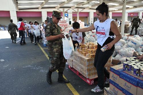 Soldiers and volunteers prepare to deliver rescue materials to local residents in the quake-devastated Talcahuano, south Chile, March 3, 2010. [Jorge Villegas/Xinhua] 