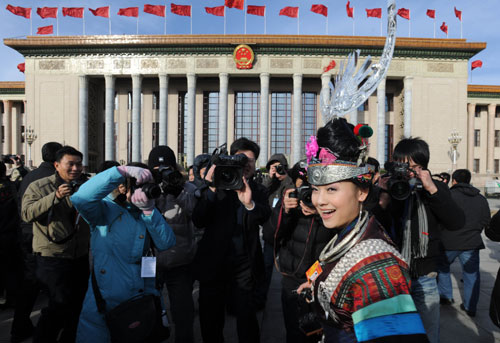 A deputy to the Third Session of the 11th National People's Congress (NPC) walks to the Great Hall of the People in Beijing, capital of China, March 5, 2010. The Third Session of the 11th NPC opened on Friday. [Jin Liangkuai/Xinhua]