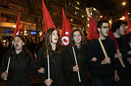 Greek demostrators shout slogans during a protest march against the austerity measures announced by the government in central Athens, capital of Greece, March 4, 2010. The Greek government ruled out on Thursday any possibility of backing off from an austerity plan it announced on Wednesday to fight the deficit, despite a string of protests against the measures. [Marios Lolos/Xinhua]