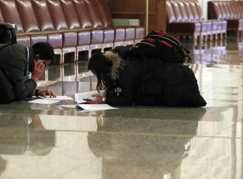 Journalists work prior to the opening meeting of the Third Session of the 11th National People's Congress (NPC) at the Great Hall of the People in Beijing, capital of China, March 5, 2010. [Fei Maohua/Xinhua]