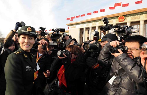 Journalists interview Tan Jing, a deputy to the Third Session of the 11th National People's Congress (NPC) prior to the opening meeting of the Third Session of the 11th NPC outside the Great Hall of the People in Beijing, capital of China, March 5, 2010. [Yang Zongyou/Xinhua]