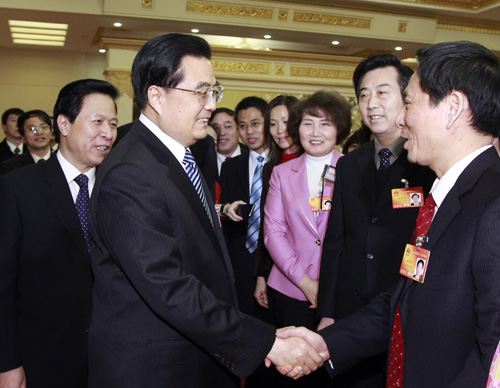 Chinese President Hu Jintao (L, front), meets with deputies to the Third Session of the 11th National People's Congress (NPC) from east China's Jiangsu Province, in Beijing, capital of China, March 5, 2010. Hu Jintao joined in the panel discussion of Jiangsu delegation on the opening day of the Third Session of the 11th NPC. [Li Xueren/Xinhua]