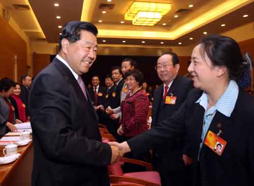 Jia Qinglin (L, front), chairman of the National Committee of the Chinese People's Political Consultative Conference (CPPCC), talks with deputies to the Third Session of the 11th National People's Congress (NPC) from Beijing, in Beijing, capital of China, March 5, 2010. Jia Qinglin joined in the panel discussion of Beijing delegation in deliberating the government work report by Premier Wen Jiabao on the opening day of the Third Session of the 11th NPC. [Liu Weibing/Xinhua]