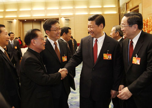 Chinese Vice President Xi Jinping (2nd R, front) talks with a deputy to the Third Session of the 11th National People's Congress (NPC) from east China's Shanghai Municipality, in Beijing, capital of China, March 5, 2010.