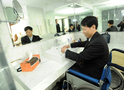 Wang Shuming, member of the 11th National Committee of the Chinese People's Political Consultative Conference (CPPCC) uses a sink in a toilet free of all obstacles at Beijing Railway Hotel in Beijing, China, March 2, 2010. Convenient services are provided for CPPCC members with special needs during the Third Session of the 11th CPPCC National Committee in Beijing. (Xinhua/Jin Liangkuai)
