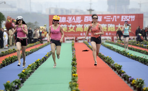 Women race in swimsuits, wigs and high-heeled shoes in southwest China's Chongqing municipality, March 7, 2010, to celebrate the International Women's Day, which falls on March 8. Forty women participated in the 120-meter race, and the final top three were given cash rewards of 1,000 yuan (first place), 500 yuan (second) and 300 yuan (third) respectively. [Photo/CFP]