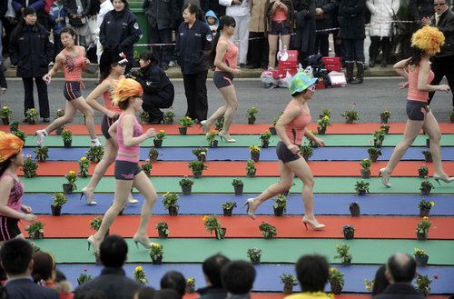 Women race in swimsuits, wigs and high-heeled shoes in southwest China's Chongqing municipality, March 7, 2010, to celebrate the International Women's Day, which falls on March 8. [Photo/CFP]