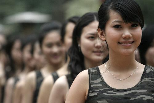 Girls stand in line during the opening ceremony of a training camp in Hangzhou, capital of east China's Zhejiang Province, March 8, 2010. Nearly 300 girls from across China began a 2-month training session Monday in Hangzhou and Shanghai in preparation for their work as hostesses during the 2010 Shanghai World Expo. [Xinhua]