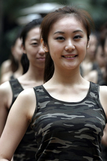 Girls stand in line during the opening ceremony of a training camp in Hangzhou, capital of east China's Zhejiang Province, March 8, 2010. Nearly 300 girls from across China began a 2-month training session Monday in Hangzhou and Shanghai in preparation for their work as hostesses during the 2010 Shanghai World Expo. [Xinhua]