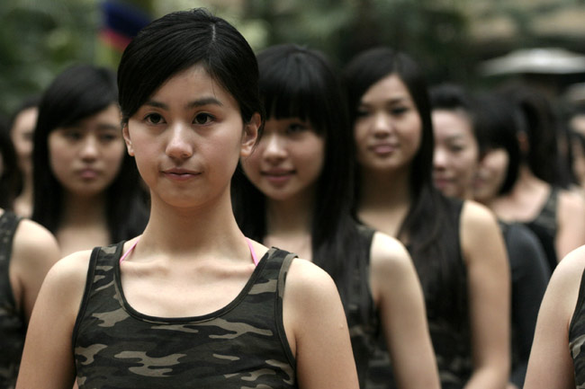 Girls stand in line during the opening ceremony of a training camp in Hangzhou, capital of east China's Zhejiang Province, March 8, 2010. Nearly 300 girls from across China began a 2-month training session Monday in Hangzhou and Shanghai in preparation for their work as hostesses during the 2010 Shanghai World Expo. [Xinhua]