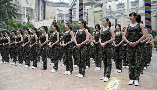 Girls stand in line during the opening ceremony of a training camp in Hangzhou, capital of east China's Zhejiang Province, March 8, 2010. Nearly 300 girls from across China began a 2-month training session Monday in Hangzhou and Shanghai in preparation for their work as hostesses during the 2010 Shanghai World Expo. [Xinhua]