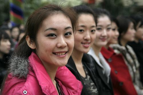 Girls stand in line during the opening ceremony of a training camp in Hangzhou, capital of east China's Zhejiang Province, March 8, 2010. Nearly 300 girls from across China began a 2-month training session Monday in Hangzhou and Shanghai in preparation for their work as hostesses during the 2010 Shanghai World Expo. [Xinhua]