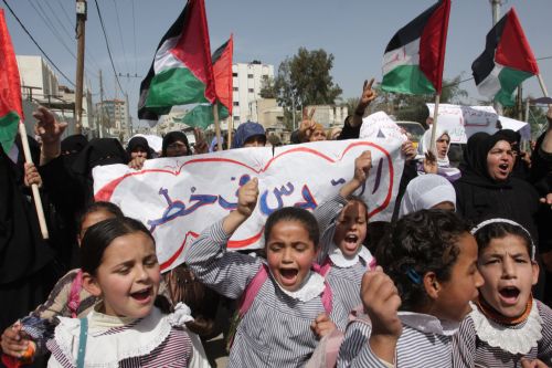 Palestinian schoolgirls chant anti-Israel slogans during a demonstration in Rafah, southern Gaza Strip on March 8, 2010. [Khaled Omar/Xinhua] 