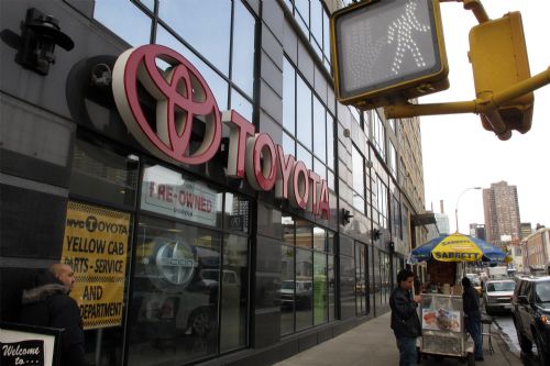A pedestrian passes by a Toyota showroom in New York, March 2, 2010. It was announced on Monday that Toyota has informed more than 1 million American and Japanese customers of a fault that leads to an oil leak in Toyota vehicles. [Wu Kaixiang/Xinhua]