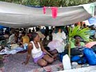 Haitian and Chilean women endure tents