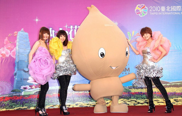 Taiwan gril band, S.H.E. pose with Yabi, the mascot of the 2010 Taipei International Flora Expo, at a press conference in Taipei on March 8. They unveiled the theme song of the flora expo, 'SHERO', at the press conference. They will also be the event's goodwill ambassadors. The flora exposition is due to kick off on Nov 6. 