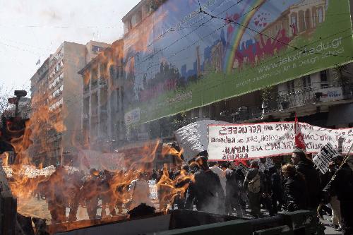 Demonstrators protest in Athens, capital of Greece, on March 11, 2010. Violent clashes between police and groups of hooded youths broke out in central Athens on Thursday, marring a massive demonstration against government austerity measures aiming to tackle the cash-strapped country&apos;s economic troubles. [Marios Lolos/Xinhua]