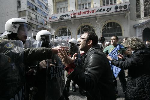 Demonstrators clash with policemen in Athens, capital of Greece, on March 11, 2010. Violent clashes between police and groups of hooded youths broke out in central Athens on Thursday, marring a massive demonstration against government austerity measures aiming to tackle the cash-strapped country&apos;s economic troubles.[Marios Lolos/Xinhua]