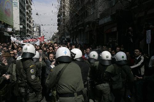 Demonstrators clash with policemen in Athens, capital of Greece, on March 11, 2010. Violent clashes between police and groups of hooded youths broke out in central Athens on Thursday, marring a massive demonstration against government austerity measures aiming to tackle the cash-strapped country&apos;s economic troubles. [Marios Lolos/Xinhua]