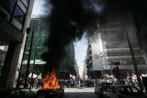 Demonstrators clash with policemen in Athens, capital of Greece, on March 11, 2010. Violent clashes between police and groups of hooded youths broke out in central Athens on Thursday, marring a massive demonstration against government austerity measures aiming to tackle the cash-strapped country&apos;s economic troubles.[Marios Lolos/Xinhua]