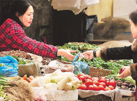 Business is brisk at a farm produce market in Nanjing, Jiangsu province, on Thursday. Food prices were the driving force behind February's CPI increase. 