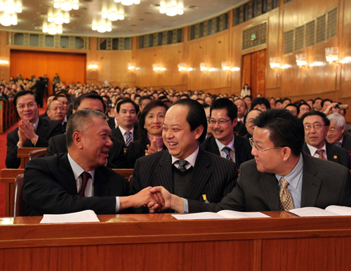 Edmund Ho Hau Wah (L, front) is congratulated by members of the 11th National Committee of the Chinese People's Political Consultative Conference (CPPCC) after being elected vice chairman of the National Committee of the Chinese People's Political Consultative Conference (CPPCC) at the closing ceremony of the Third Session of the 11th CPPCC National Committee at the Great Hall of the People in Beijing, capital of China, March 13, 2010. [Xinhua]