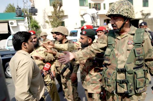 Security personnel stand guard at the site of blast in the eastern Pakistani city of Lahore on March 12, 2010. [Jameel Ahmed/Xinhua]