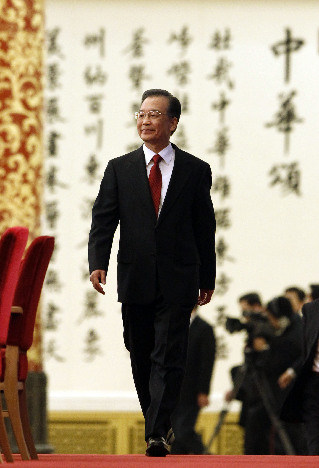 Chinese Premier Wen Jiabao smiles during a press conference after the closing meeting of the Third Session of the 11th National People&apos;s Congress (NPC) at the Great Hall of the People in Beijing, capital of China, March 14, 2010.