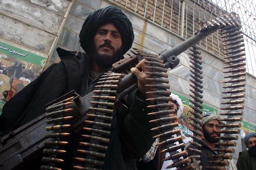 Taliban fighters defect to the government and hand over weapons to authorities in Shindand district of Herat province, Afghanistan, on March 14, 2010. Thirty Taliban fighters defected to the government here on Sunday. [Melad/Xinhua]