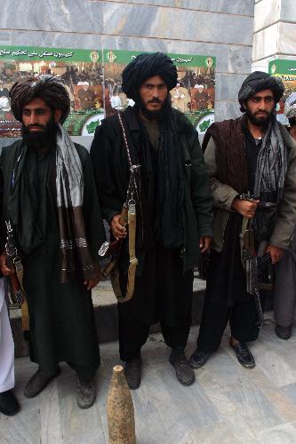 Taliban fighters defect to the government and hand over weapons to authorities in Shindand district of Herat province, Afghanistan, on March 14, 2010. Thirty Taliban fighters defected to the government here on Sunday. [Melad/Xinhua] 