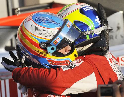 Ferrari's Spanish driver Fernando Alonso (L) celebrates with his teammate Felipe Massa after winning the Bahrain F1 Grand Prix at Sakhir circuit in Manama March 14, 2010. Alonso won his Ferrari debut with 1h 39m 20.396s. (Xinhua/Zhang Ning)