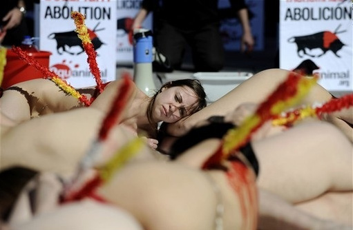 Animals rights activists covered in fake blood protest during a demonstration calling for the abolition of bullfights in Valencia March 14, 2010.[CRIOnline.com]