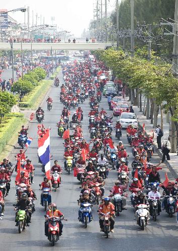 Supporters of former Thai premier Thaksin Shinawatra gather for a protest outside the base of Thai Army 11th Infantry Regiment in Bangkok, capital of Thailand, March 15, 2010. Thousands of protesters on Monday rallied outside the base where the premier Abhisit Vejjajiva had his crisis headquarters to call on him dissolve the parliament, but Abhisit refused.[Lui Siu Wai/Xinhua]