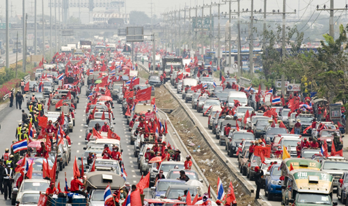 Members of &apos;red-shirts&apos;, supporters of the United Front for Democracy against Dictatorship (UDD), travel to Bangkok, capital of Thailand, March 13, 2010. The demonstration organized by the UDD started on Friday when the red-shirted supporters of fugitive former Prime Minister Thaksin Shinawatra are traveling to Bangkok. [Lui Siu Wai/Xinhua]