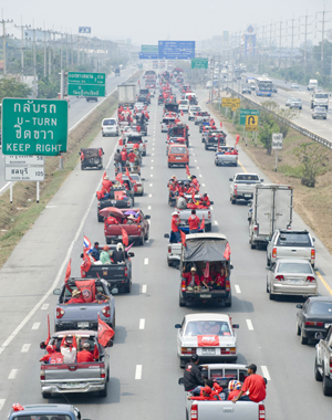 Members of &apos;red-shirts&apos;, supporters of the United Front for Democracy against Dictatorship (UDD), travel to Bangkok, capital of Thailand, March 13, 2010. The demonstration organized by the UDD started on Friday when the red-shirted supporters of fugitive former Prime Minister Thaksin Shinawatra are traveling to Bangkok. [Lui Siu Wai/Xinhua]