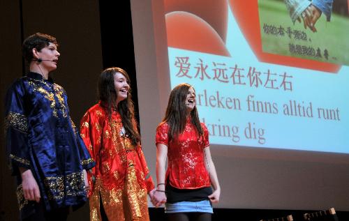 Three middle school students sing a Chinese song during the second 'Chinese Bridge' Chinese language competition of Swedish middle school and university students in Stockholm, capital of Sweden, March 14, 2010. Nine university students and 33 middle school students took part in the competition on Sunday. [He Miao/Xinhua]