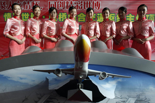 Hostesses pose for a photo after a ceremony for the opening of terminal 2 Shanghai Hongqiao International airport March 16, 2010.