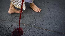 Red-shirted protestors pour blood to denounce gov't