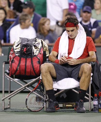 Roger Federer of Switzerland sits in his chair during a changeover in his loss to Marcos Baghdatis of Cyprus during their match at the Indian Wells ATP tennis tournament in Indian Wells, California, March 16, 2010. (Xinhua/Reuters Photo)