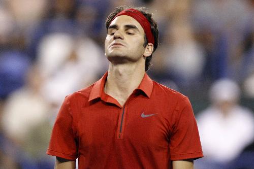 Roger Federer of Switzerland reacts after losing a point against Marcos Baghdatis of Cyprus during their match at the Indian Wells ATP tennis tournament in Indian Wells, California, March 16, 2010. (Xinhua/Reuters Photo)