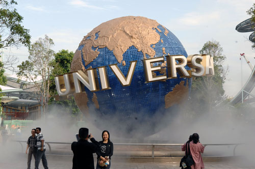 Visitors take photos in the Universal Studios theme park on the Sentosa Island in Singapore, March 16, 2010. The Universal Studios theme park including Hollywood, Ancient Egypt, Lost World, Madagarscar and three other theme sections, will open to the public on March 18. 