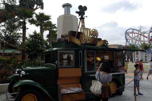 A visitor takes photos in the Universal Studios theme park on the Sentosa Island in Singapore, March 16, 2010.